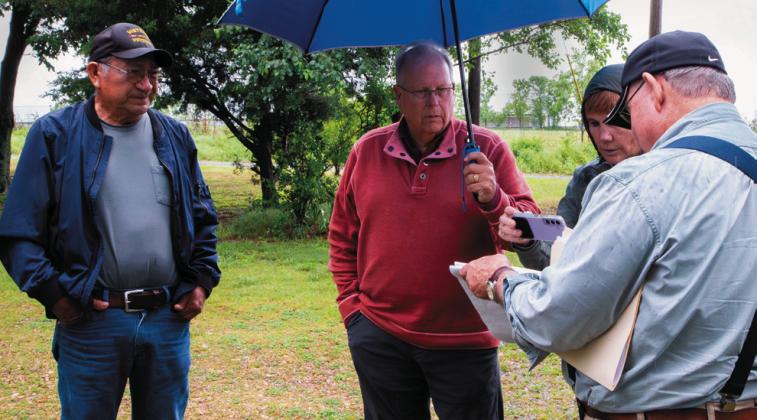 Adair County resident Clarence Manning, left, speaks with attorney David Page, center, microbiologist Valerie Harwood and geochemist Bert Fisher at his home just downhill from a large poultry operation. Photo by Kelly J Bostian / KJBOutdoors