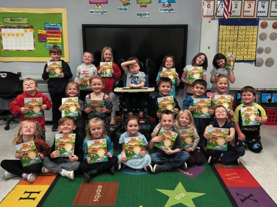 Mrs. Roe’s kindergarten class with their sign language books donated by Morrison Special Olympics.