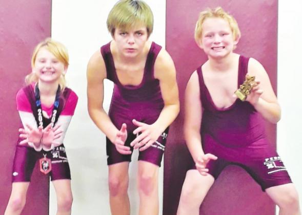 Three Perry Youth Wrestlers recently competed at the Ponca Tournament. Above, from left are wrestlers Alexus Dunagan G7U 50# - 3rd, Isander Woodruff O15U 112#, and Kieren Postier N8U Hwt - Champion.