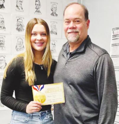 December Student of the Month for Covington-Douglas High School, Makayla Chartier is pictured above at left with nominating educator Bryan Hall.