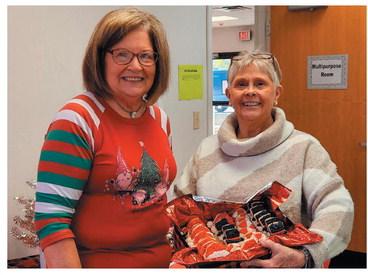 At right are Perry Study Club members Marilynn Voise and Karen Demory, auctioneers for Perry Study Club’s annual Christmas Auction. Above are all members in attendance.