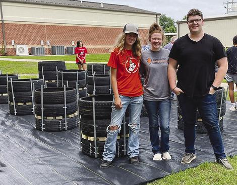 Wetumka High School students work on building recycled tire gardens. They’ve harvested radishes and are currently growing various types of lettuces.