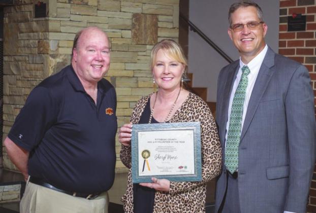 Sheryl Moore, center, pictured with Moore are Greg Owen, Pittsburg County OSU Extension educator, left, and Steve Beck, State 4- H program leader, right. (Photo by Todd Johnson, OSU Agricultural Communications)
