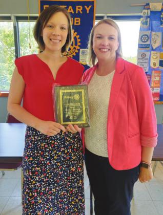 Outgoing President Jessica Dvorak pictured above at left with plaque commemorating year of service given to her by April Bond, President, right.