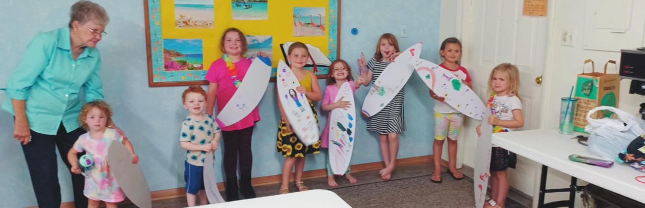 Throughout the three days, children participated in songs, outdoor games, snacks, and crafts. The craft on the first day, Thursday, June 16, was decorating surfboards.