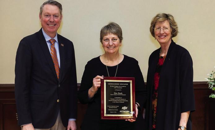Dea Rash, Payne County family and consumer sciences educator, (center) receives the Distinguished Educator award from Jayson Lusk, vice president and dean of OSU Agriculture, (left) and Damona Doye, associate vice president of OSU Extension, (right) at the 2024 OSU Extension Biennial Conference. (Photo by Mitchell Alcala, OSU Agriculture)