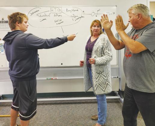 Tom Fox and his son, Austin, demonstrate self-defense techniques to Perry Study Club member, Gina Bolay. Fox is the owner of Fox’s Kung Fu.