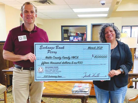 Pictured above is Exchange Bank President Zach Hall presenting a check for $15,000 to Shea Boschee, Noble County Family YMCA CEO