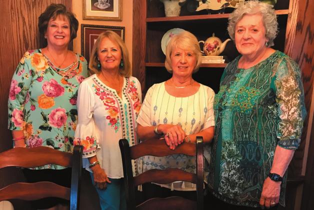 Pictured above are hostesses Pam Dvorak, Bev Crowe, Cindy St. Clair and Carolyn Keating. Below, from left, are guests Lois Malget and Caroline Malget with President Carrie Hall. Caroline was recipient of the P.E.O. Scholarship.